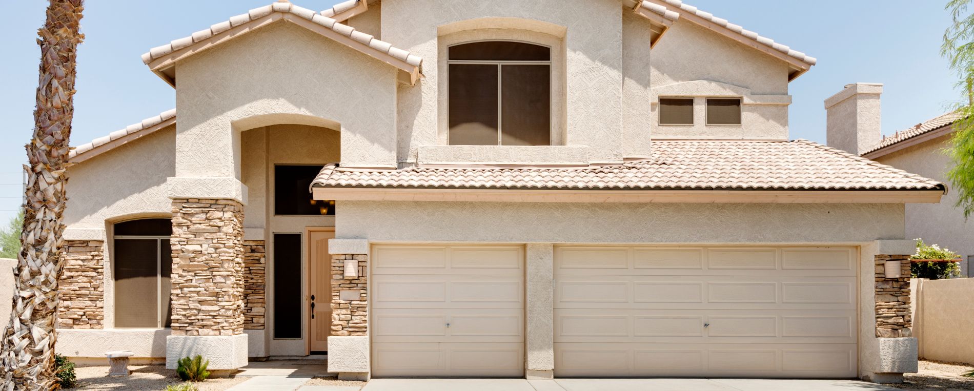 Modern two-story home with double garage doors in Saratoga Springs, Utah
