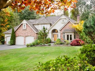 About Garage Door Repair Saratoga Springs Front view of a suburban home with a new garage door and fenced yard in Saratoga Springs.